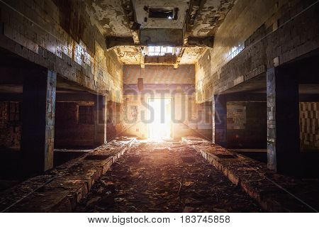 Corridor in abandoned factory building in Voronezh, Russia. Perspective, light in the end concept.