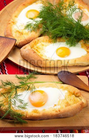 ajarian khachapuri dish of Georgian cuisine, Georgian national pastry, which is a flatbread with cheese. baked in the shape of boats and pour the egg