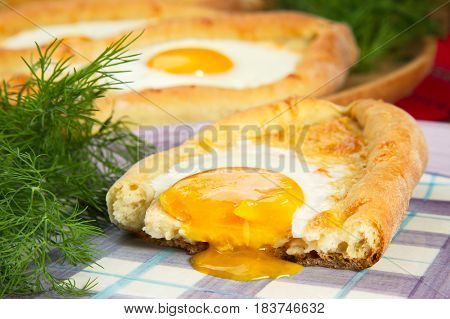ajarian khachapuri dish of Georgian cuisine, Georgian national pastry, which is a flatbread with cheese. baked in the shape of boats and pour the egg