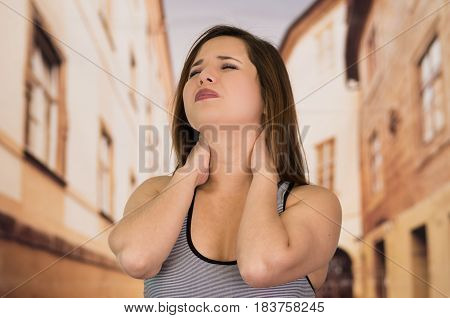 Beautiful lady Suffer crick after workout in the street.