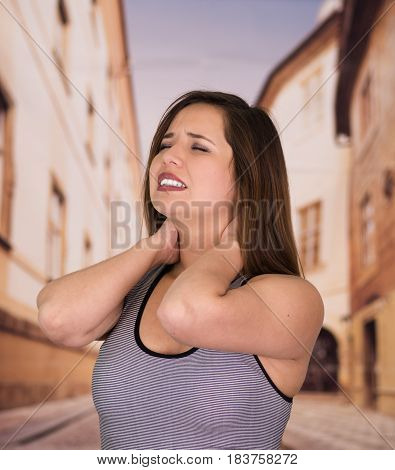 Beautiful lady Suffer crick after workout in the street.