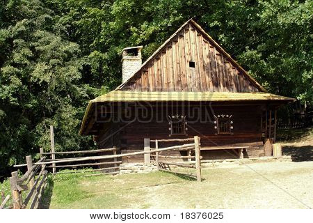 An old historic houses in museum â Roznov Skansen - Wallachian Village open air museum- in Czech republic in Europe under mountains by name Beskydy