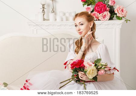 Sweet ballerina in a stage costume holds a bouquet of spring flowers. Retro dress. A gift from a fan.
