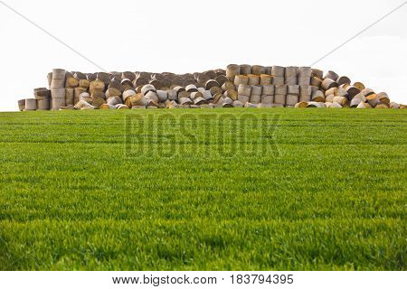 Haystack in middle of the field prepared animal fodder on a farm. Agriculture mass production livestock breeding concept with copy space.