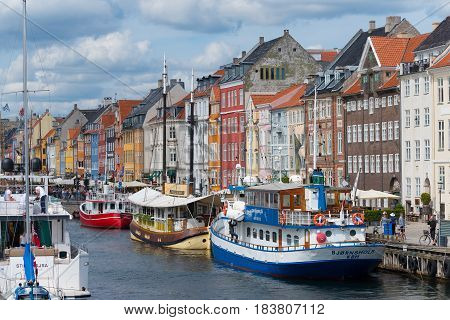 COPENHAGEN DENMARK - JULY 31 2016: Summer view of the famous Nyhavn with its colorful buildings