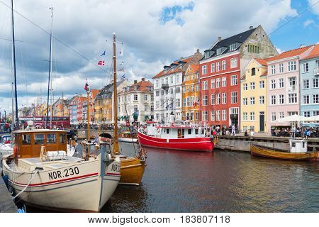 COPENHAGEN DENMARK - JULY 31 2016: Summer view of the famous Nyhavn with its colorful buildings
