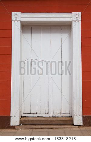 Typical colonial building with big and small doors Trinidad Cuba