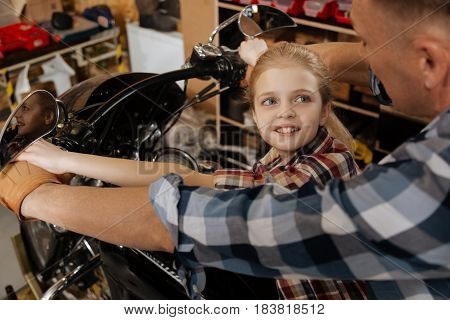 I have an idea. Inspired eager sympathetic girl talking to her dad about her ideas while thy sitting on a bike and planning future rides