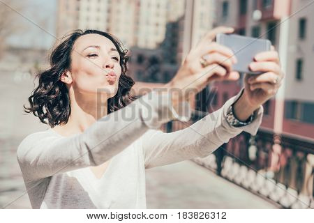 The Girl Poses On The Phone, Photos Herself, Makes A Photo For Social Networks.