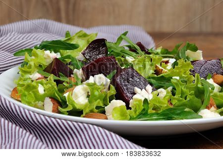 Salad vinaigrette with beets lettuce arugula feta and almonds