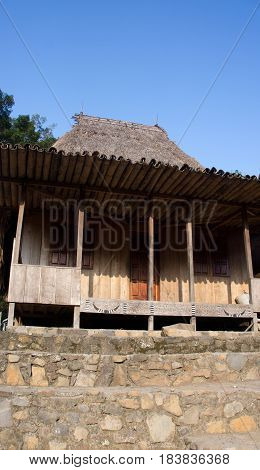 Front of wooden house in Bena a traditional village with grass huts of the Ngada people in Flores near Bajawa Indonesia.