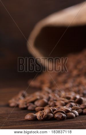 Coffee Is Poured From A Burlap On A Wooden Background