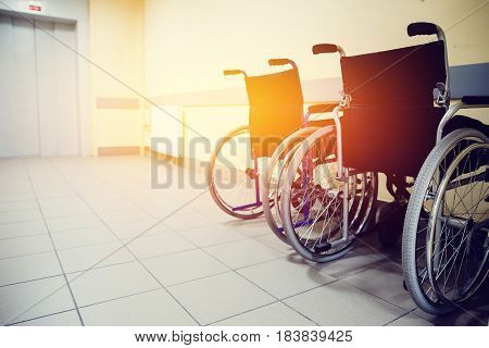 wheelchair is in the hospital near the elevator. Concept assistance in the movement.high contrast and monochrome color tone. Toning.