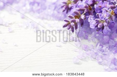Few sprigs of lavender and  mineral bath salts on  the wooden table.  Shallow DOF. Selective focus