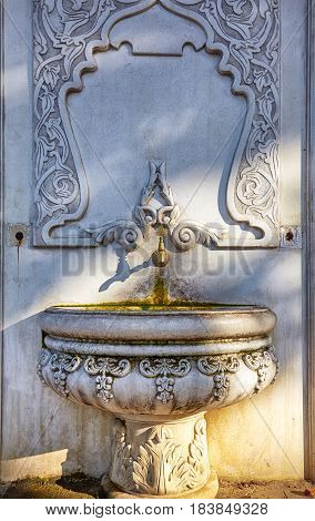 A warm sun glow lying on fountain in historical urban Gulhane Park. Istanbul Turkey