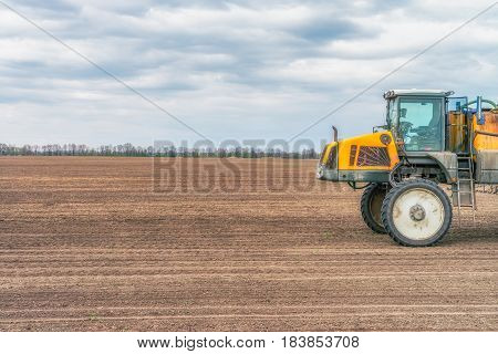 KREMENCHUK, UKRAINE - APRIL 22, 2017: Tractor preparing the field before seeding the ground. Wheat - main crops, which are grown in Ukraine