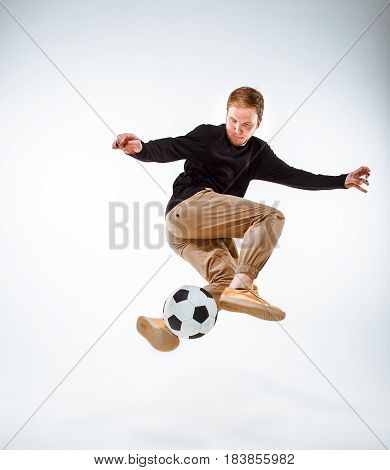 A portrait of a fan with ball on gray studio background. Freestile concept