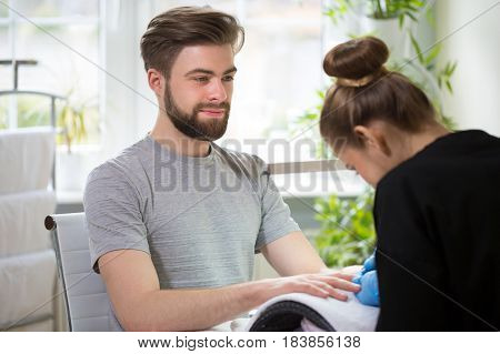 Close-up of man's hands at beautician's during manicure