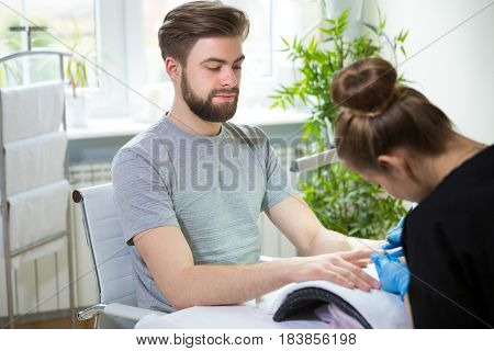 Close-up of man's hands at beautician's during manicure