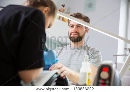 Close-up of man's hands at beautician's during manicure
