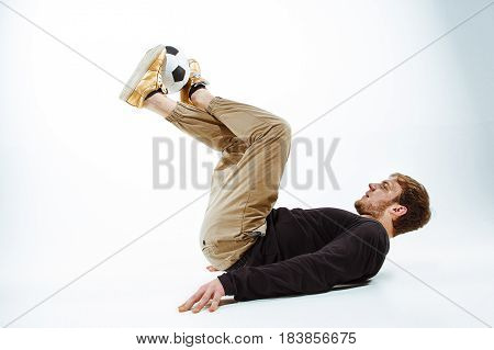 A portrait of a fan with ball on gray studio background. Freestile concept
