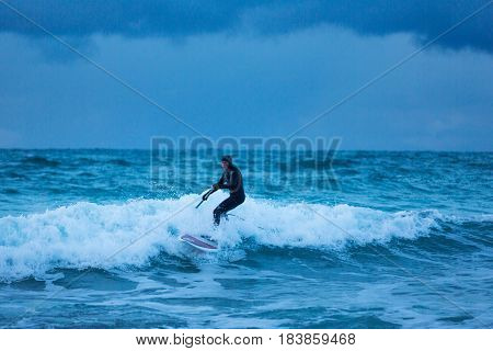 Flakstad Norway - March 18 2017: Surfer are training on the Skagsanden beach of the Lofoten Islands