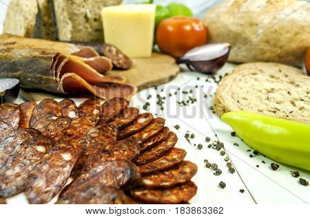 Healthy vegetables and sirloin and sousage on a wooden white table and dietary bread