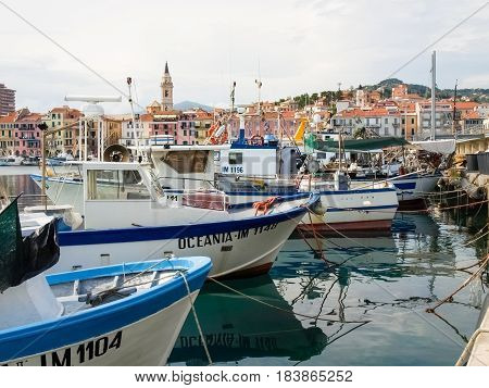 Oneglia Italy - June 9 2015: Marina and fishing. Several fishing boats are moored. In the background the buildings typical of Oneglia.