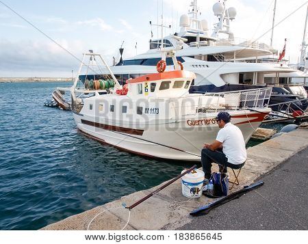 Fisherman Sitting At The Port
