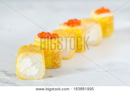 Rolls With Caviar In An Omelette On A White Background