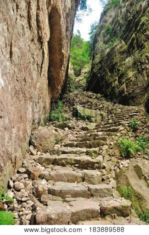 A stone stairwell leading up near a cliff in the Fangdong Scenic Area on Yandangshan mountains located in Zhejiang province China.
