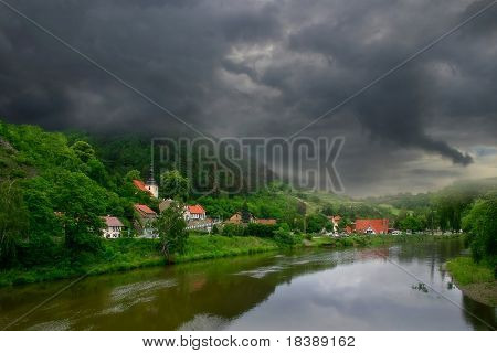View on river and green hills of Karlstejn village near Prague, Czech Republic.