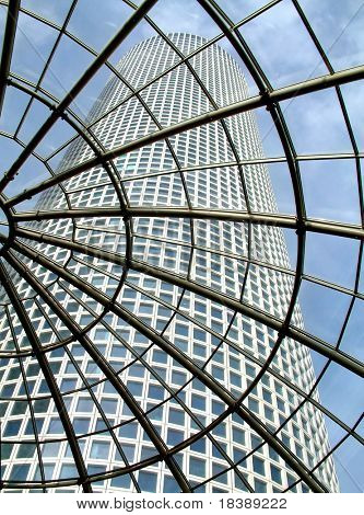 Modern glass roof in Azrieli shopping center with view on skyscraper.
