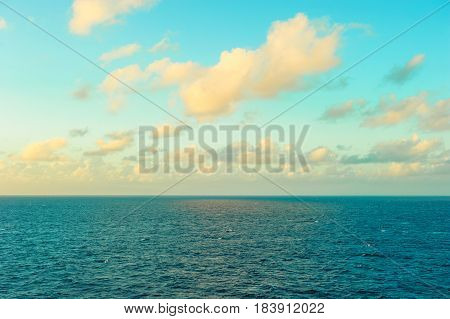 Turquoise sea water and perfect blue sky with white clouds. Sunset seacape