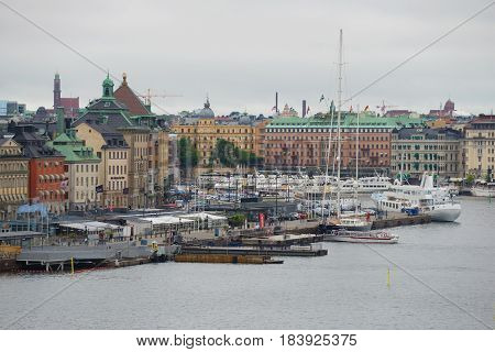 STOCKHOLM, SWEDEN - AUGUST 29, 2016: Skeppsbron embankment in the Old City on a cloudy August day