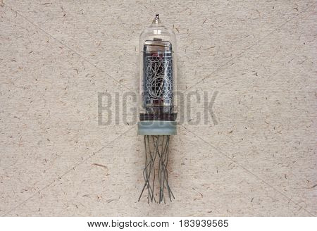Close-up view of vintage nixie tube indicator of the numbers on craft paper background