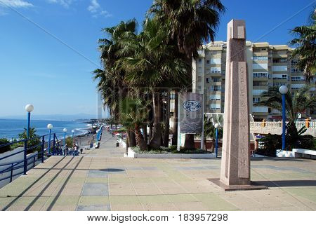 TORROX COSTA, SPAIN - OCTOBER 27, 2008 - Greenwich obelisk along the promenade with pavement cafes to the right hand side and the beach to the left Torrox Costa Malaga Province Andalusia Spain Western Europe, October 27, 2008.