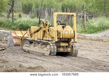 detail of buldozer in a meadow in italy