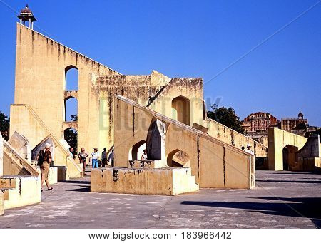 JAIPUR, INDIA - NOVEMBER 24, 1993 - View of the giant sundial known as the Samrat Yantra at Jantar Mantar Jai Singhs Observatory with people enjoying the sights Jaipur Rajasthan India, November 24, 1993.