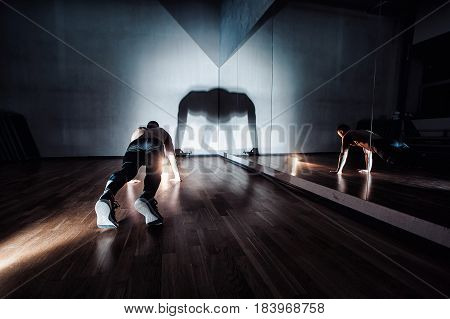 Attractive Muscular Man Doing Push-ups On A Wooden Floor.