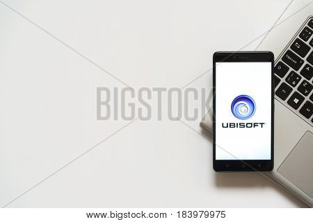 Bratislava, Slovakia, April 28, 2017: Ubisoft logo on smartphone screen placed on laptop keyboard. Empty place to write information.