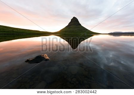 Colorful sunrise on Kirkjufellsfoss waterfall. Amazing morning scene near Kirkjufell volkano, Iceland, Europe. Landscape photography