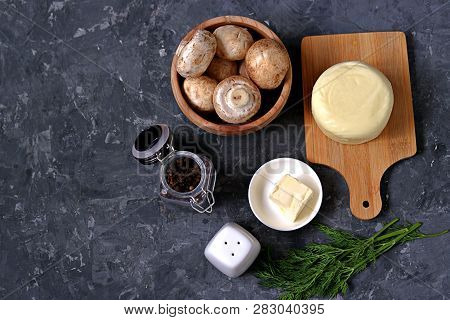 Ingredients For Cooking Baked Champignons With Suluguni On A Dark Gray Background: Raw Champignon Mu