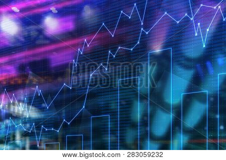 Blue Glowing Graphs And Bar Chart Over Blurred City Background. Concept Of Trading And Stock Market.