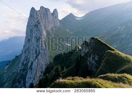 Mountain Landscape In The Swiss Alps With Jagged Peaks And A Pristine Blue Mountain Lake In The Vall