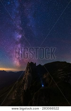 Mountain Landscape In The Swiss Alps With Jagged Peaks And A Pristine Blue Mountain Lake In The Vall