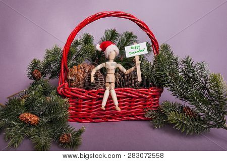 Wooden Jointed Mannequin Doll Holding Happy December Holiday Greetings Sign Sitting In A Big Red Bac