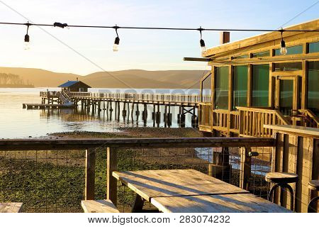 January 19, 2019 In Point Reyes, Ca:  Outdoor Patio Seating At A Restaurant Overlooking Tomales Bay 