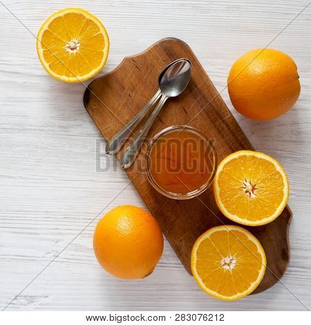 Top View, Homemade Orange Marmelade In Glass Jar On A White Wooden Background. Flat Lay, Overhead, F