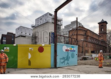 London, Uk - December 22, 2018 Builders At The Colorful Fence Near Tottenham Court Station